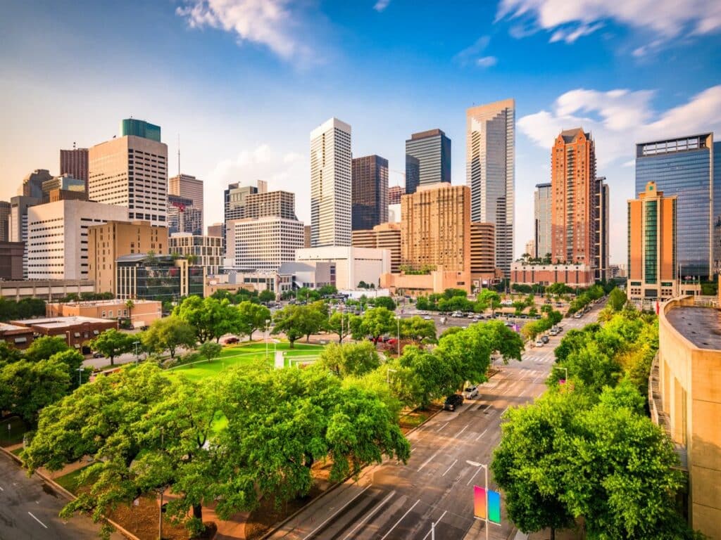 Downtown Houston skyline with modern skyscrapers and green city park views.