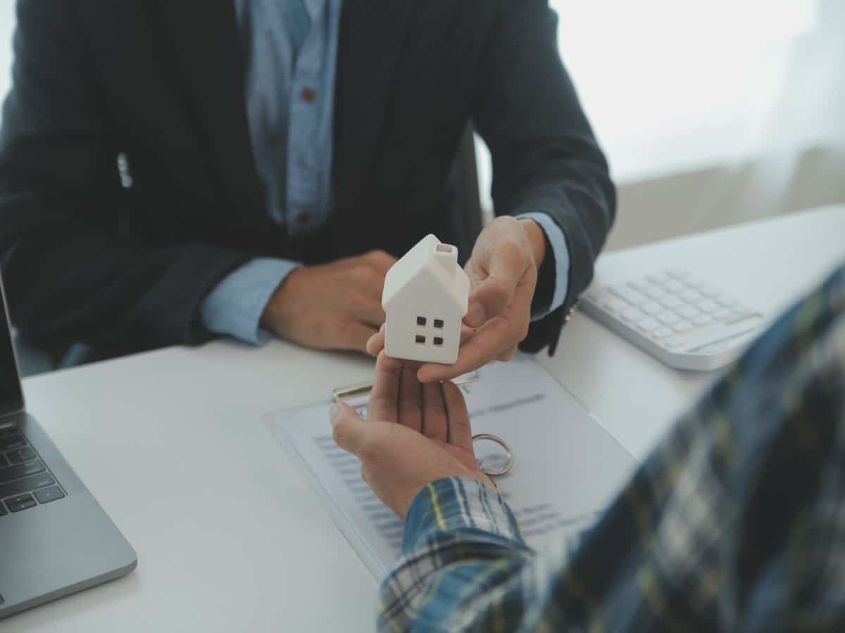 Real estate agent reviewing property documents with a client during a planning meeting