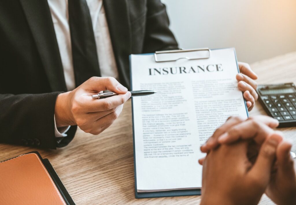 Home insurance consultation Agent explaining insurance policy details to client for home insurance in San Antonio, TX.