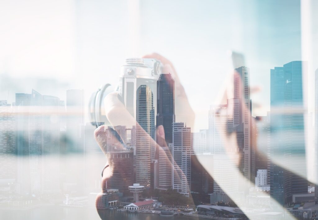 fast vetting connection Double-exposure image of a camera and a city skyline suitable for stories about real estate
