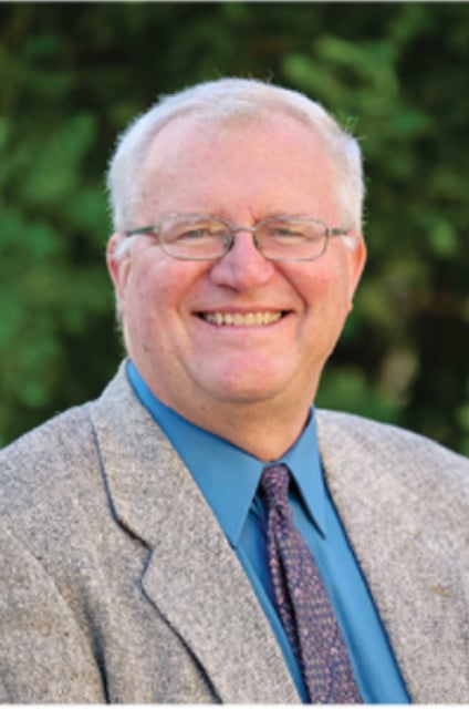 real estate agent in a suit jacket and blue tie