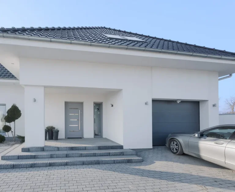 Simple, white entrance of a home with carport, the opportunities